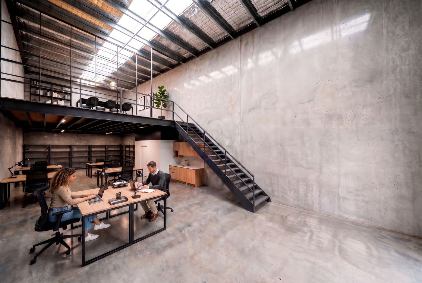 Mezzanine fitted out as an office with desks overlooking the warehouse floor
